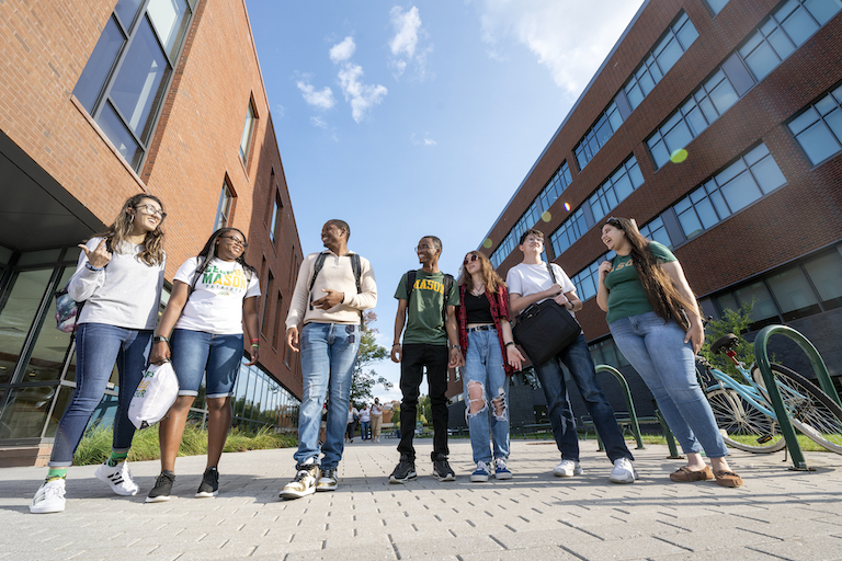 Students pose for a photo in between Fenwick Library and Horizon Hall. Photo by Evan Cantwell/Creative Services/George Mason University